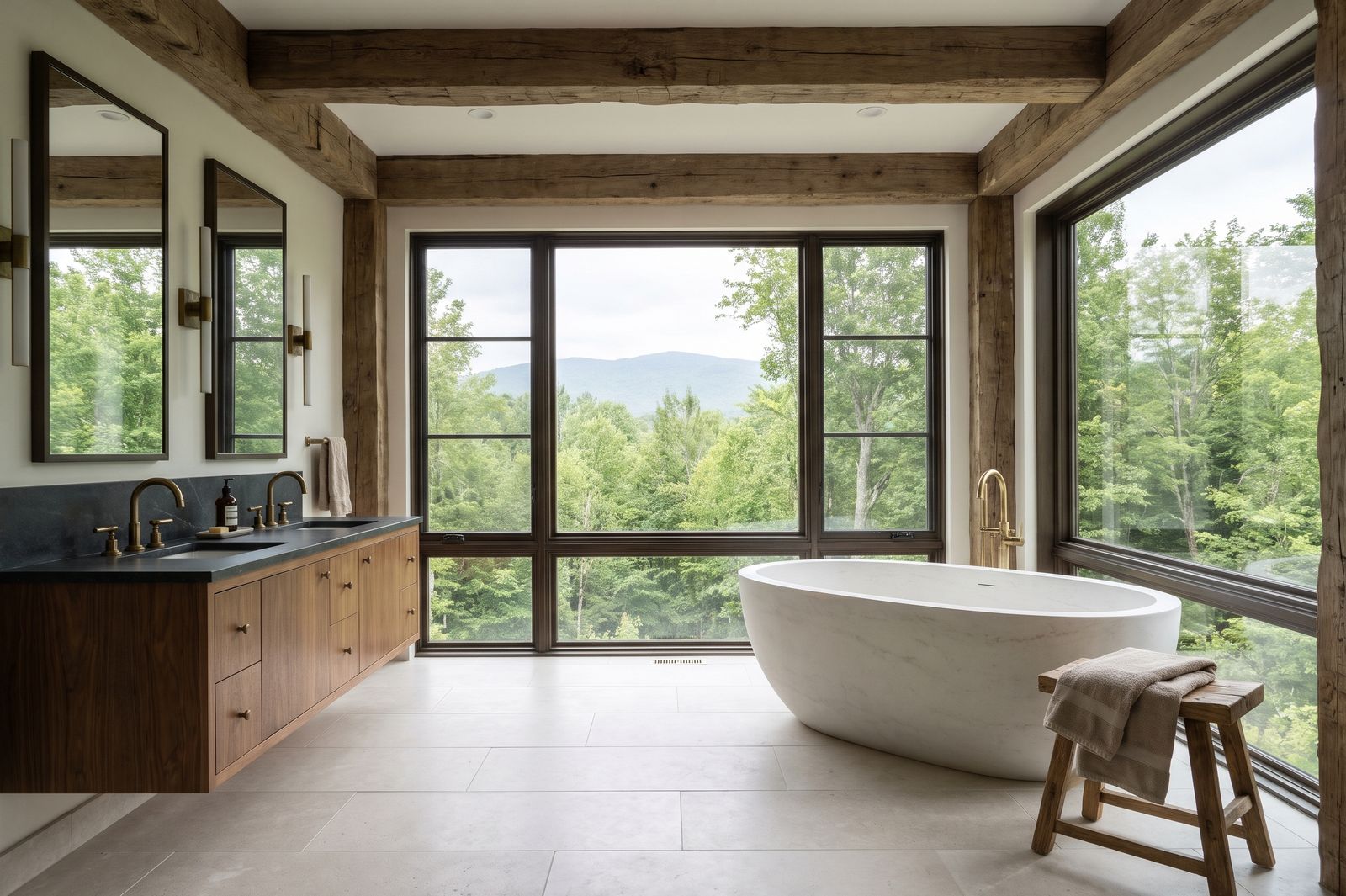 Renovated primary bath with a freestanding soaking tub, walnut vanity and a wall of glass to the mountains