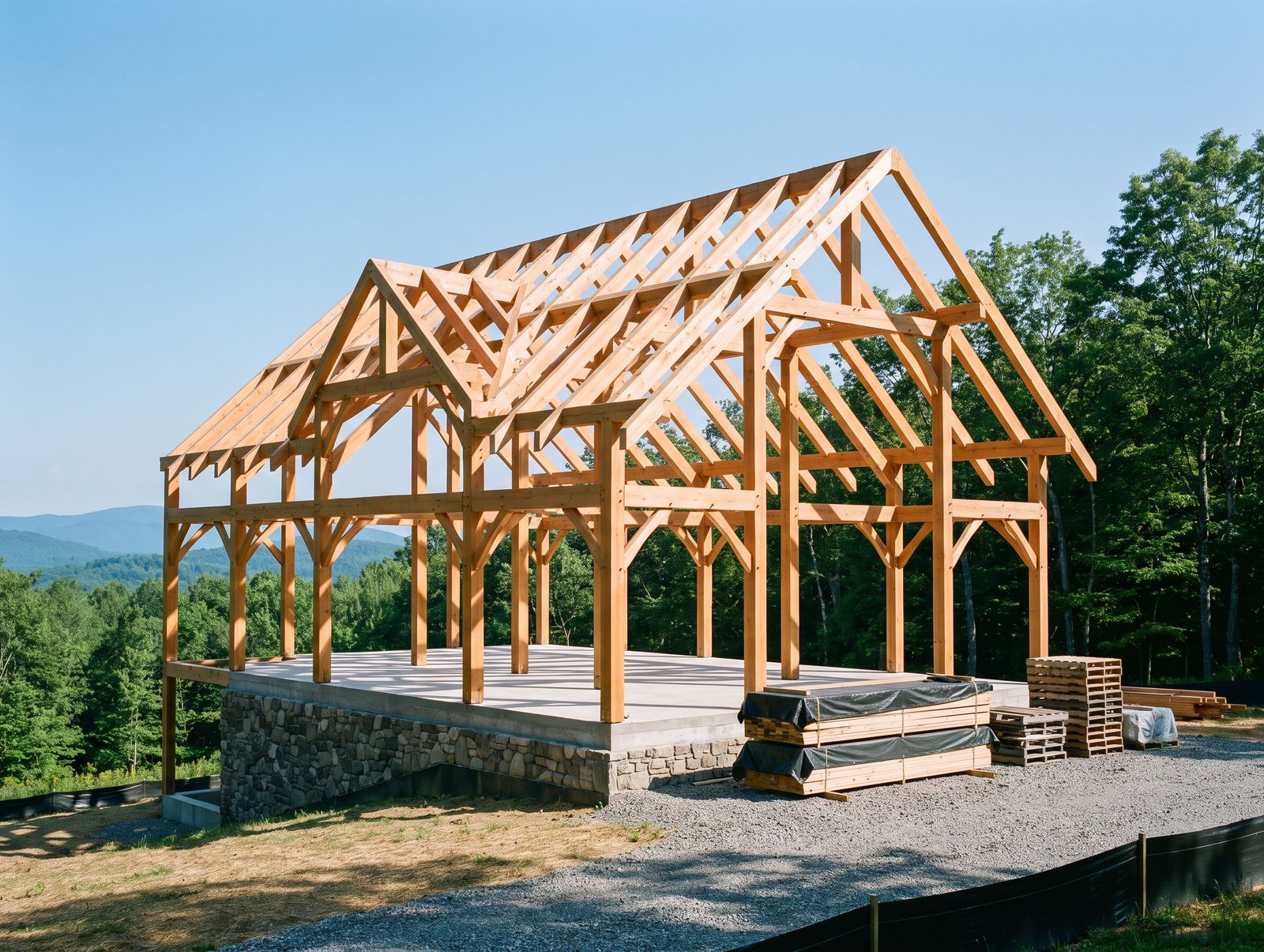 Timber frame home being raised on a stone foundation on a wooded mountain lot